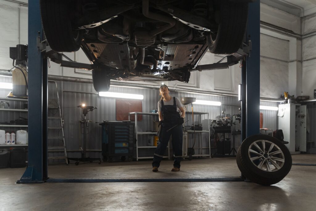 female-auto-repairer-working-shop-car